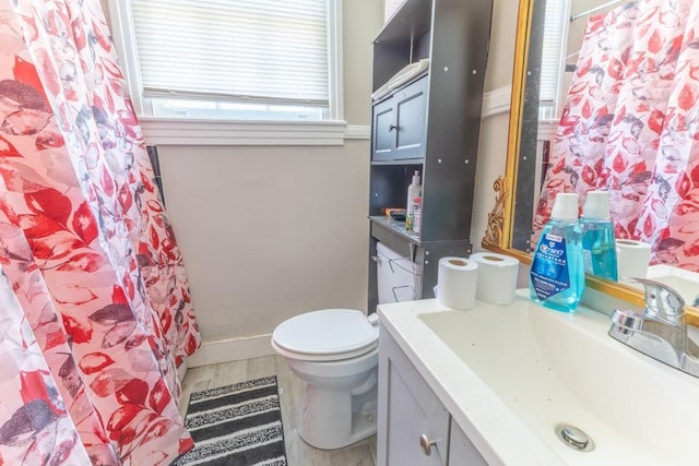 3962-64 Pauger St, New Orleans, LA 70122 - bathroom featuring toilet, vanity, and a shower with curtain