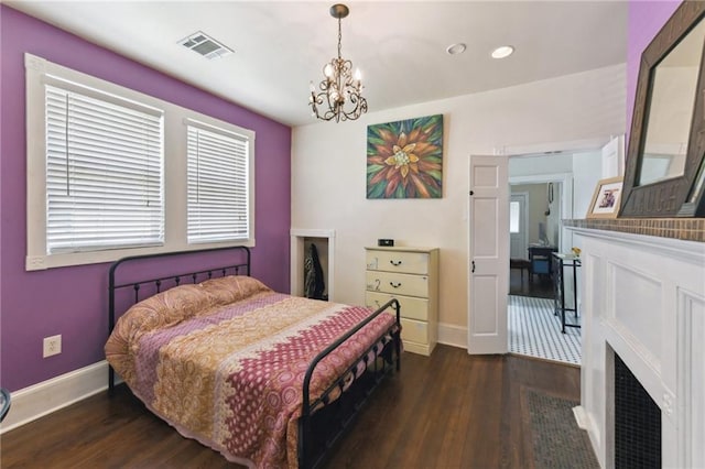 7328-30 Spruce St, New Orleans, LA 70118 - bedroom featuring wood finished floors, a chandelier, baseboards, recessed lighting, and a fireplace with flush hearth