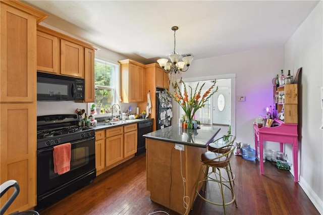 7328-30 Spruce St, New Orleans, LA 70118 - kitchen with black appliances, a chandelier, a kitchen island, dark wood-style flooring, and a sink