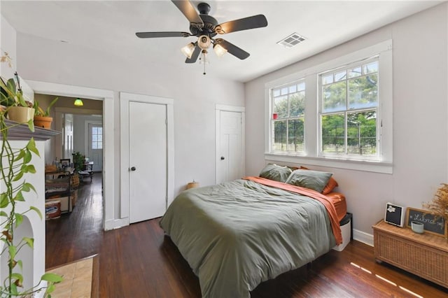 7328-30 Spruce St, New Orleans, LA 70118 - bedroom featuring multiple windows, wood finished floors, two closets, and baseboards