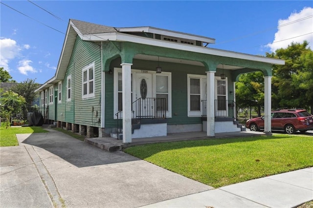 7328-30 Spruce St, New Orleans, LA 70118 - view of front of property with a front lawn and covered porch