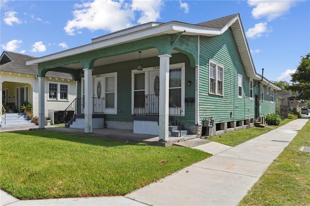 7328-30 Spruce St, New Orleans, LA 70118 - view of front of home featuring a front yard and a porch