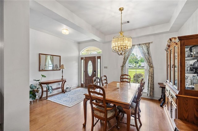 18332 Honeysuckle Dr, Ponchatoula, LA 70454 - dining room featuring healthy amount of natural light, wood finished floors, a chandelier, and baseboards