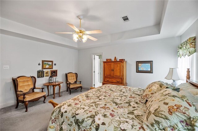 18332 Honeysuckle Dr, Ponchatoula, LA 70454 - bedroom with a raised ceiling, light carpet, and a ceiling fan