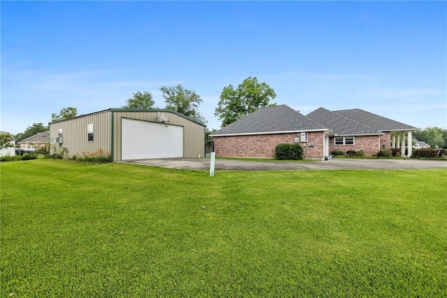 18332 Honeysuckle Dr, Ponchatoula, LA 70454 - view of front facade with a detached garage, a front yard, an outbuilding, brick siding, and a shingled roof