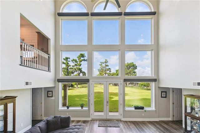 91 Rosedown Dr, Destrehan, LA 70047 - living area with a towering ceiling, french doors, wood finished floors, and healthy amount of natural light