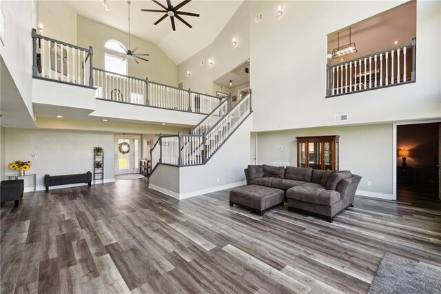 91 Rosedown Dr, Destrehan, LA 70047 - living room with ceiling fan, high vaulted ceiling, wood finished floors, stairway, and baseboards