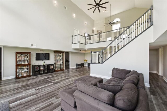 91 Rosedown Dr, Destrehan, LA 70047 - living room with high vaulted ceiling, baseboards, wood finished floors, stairway, and a ceiling fan