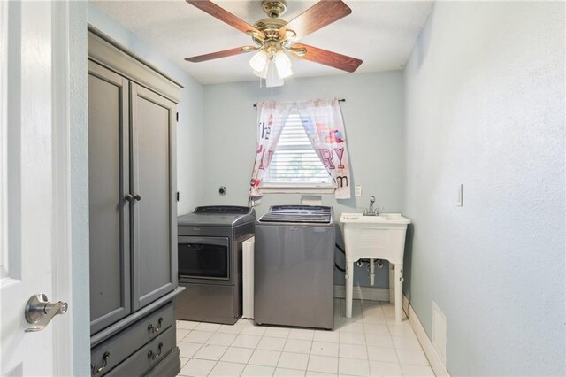 91 Rosedown Dr, Destrehan, LA 70047 - laundry room featuring cabinet space, washing machine and dryer, light tile patterned floors, and a ceiling fan
