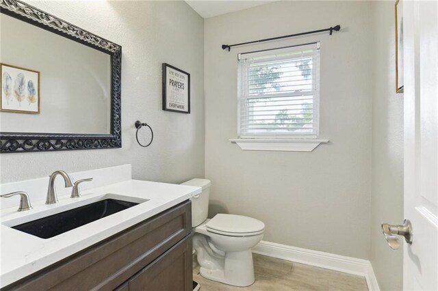 91 Rosedown Dr, Destrehan, LA 70047 - bathroom featuring toilet, vanity, baseboards, and wood finished floors