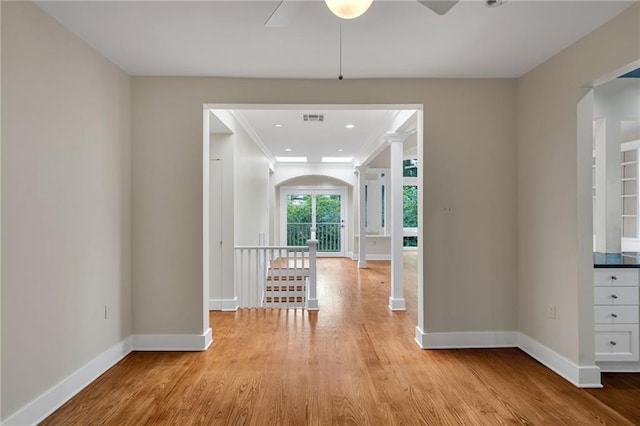 324 Fairway Dr, New Orleans, LA 70124 - hall featuring baseboards, light wood-style floors, arched walkways, and ornamental molding