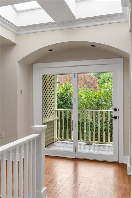 324 Fairway Dr, New Orleans, LA 70124 - hall with wood finished floors, a skylight, and arched walkways