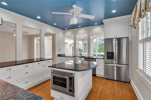 324 Fairway Dr, New Orleans, LA 70124 - kitchen featuring stainless steel appliances, ceiling fan, light wood-style floors, white cabinetry, and recessed lighting
