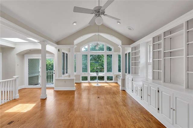 324 Fairway Dr, New Orleans, LA 70124 - empty room with decorative columns, ceiling fan, light wood finished floors, built in shelves, and vaulted ceiling