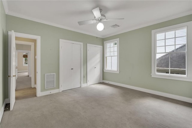 324 Fairway Dr, New Orleans, LA 70124 - unfurnished bedroom with carpet floors, multiple closets, crown molding, baseboards, and ceiling fan