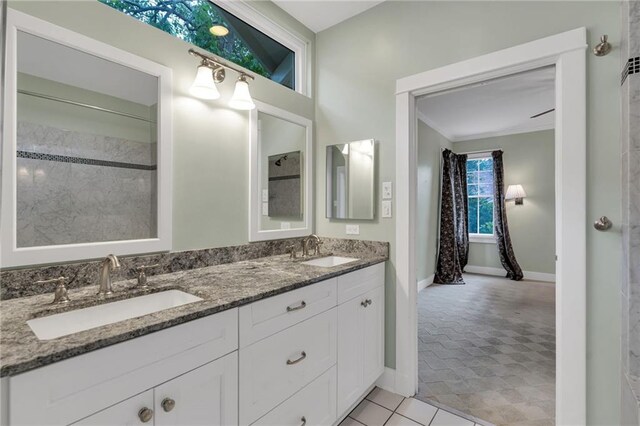 324 Fairway Dr, New Orleans, LA 70124 - full bathroom featuring double vanity, baseboards, and crown molding