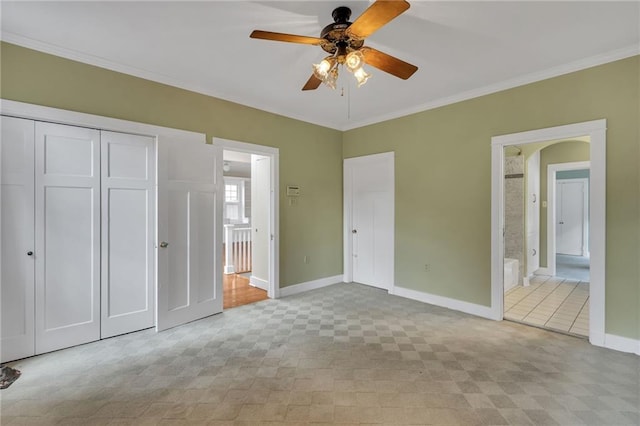 324 Fairway Dr, New Orleans, LA 70124 - unfurnished bedroom featuring baseboards, crown molding, arched walkways, a closet, and ensuite bath