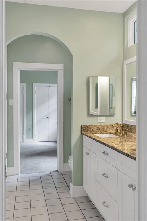 324 Fairway Dr, New Orleans, LA 70124 - bathroom featuring toilet, vanity, tile patterned flooring, and baseboards
