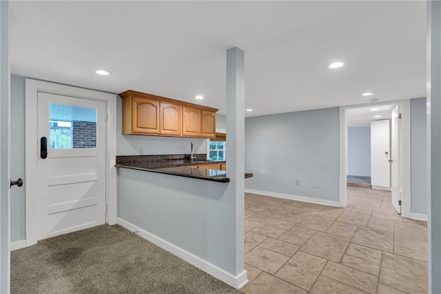324 Fairway Dr, New Orleans, LA 70124 - kitchen with dark countertops, baseboards, recessed lighting, and brown cabinets