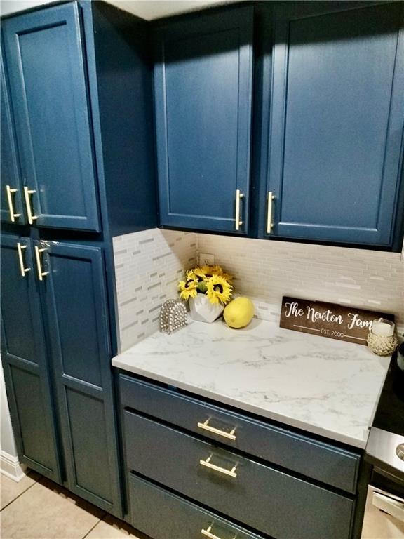 120 Whisperwood Blvd, Slidell, LA 70458 - kitchen view of blue cabinets, backsplash, and light stone countertops