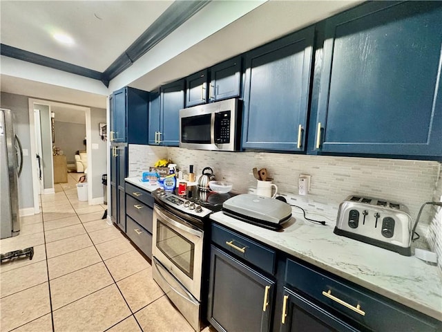 120 Whisperwood Blvd, Slidell, LA 70458 - kitchen with stainless steel appliances, light tile patterned floors, tasteful backsplash, blue cabinetry, and light stone countertops