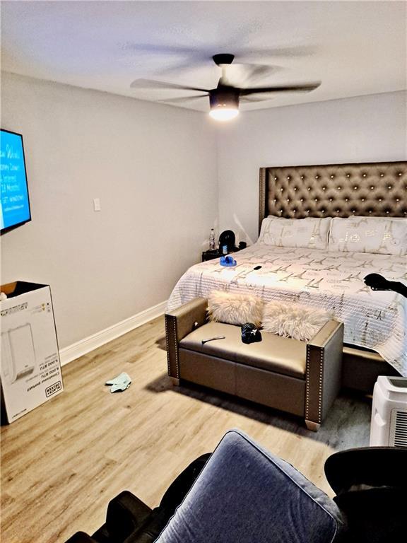 120 Whisperwood Blvd, Slidell, LA 70458 - bedroom with wood finished floors, a ceiling fan, and baseboards