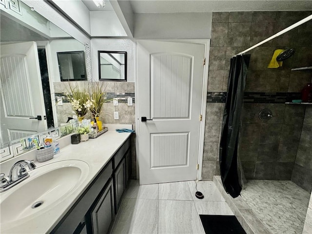 120 Whisperwood Blvd, Slidell, LA 70458 - bathroom featuring vanity, a tile shower, and tile patterned floors