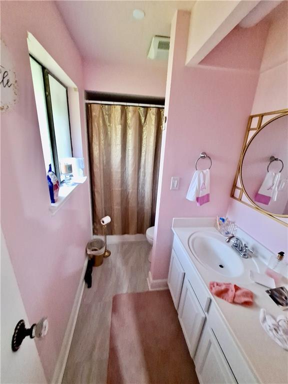 120 Whisperwood Blvd, Slidell, LA 70458 - bathroom with vanity, toilet, curtained shower, and baseboards