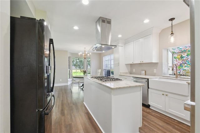 2351 Ormond Blvd, Destrehan, LA 70047 - kitchen with appliances with stainless steel finishes, island range hood, a kitchen island, white cabinets, and recessed lighting