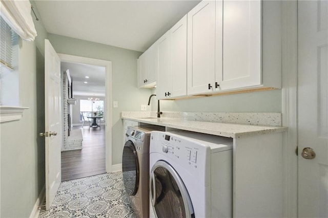 2351 Ormond Blvd, Destrehan, LA 70047 - washroom with washing machine and dryer, cabinet space, baseboards, and light tile patterned flooring