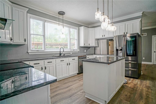 115 Devereux Dr, Slidell, LA 70461 - kitchen with a sink, stainless steel appliances, ornamental molding, a kitchen island, and wood finished floors