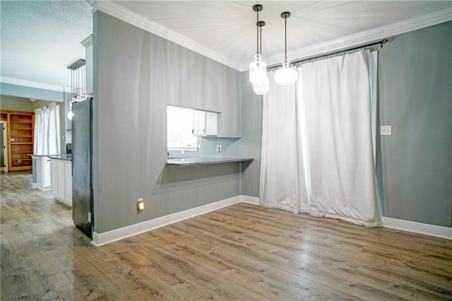 115 Devereux Dr, Slidell, LA 70461 - unfurnished dining area featuring crown molding, wood finished floors, and baseboards
