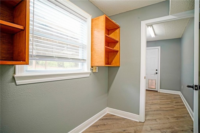 115 Devereux Dr, Slidell, LA 70461 - hallway featuring wood finished floors, baseboards, and a textured ceiling