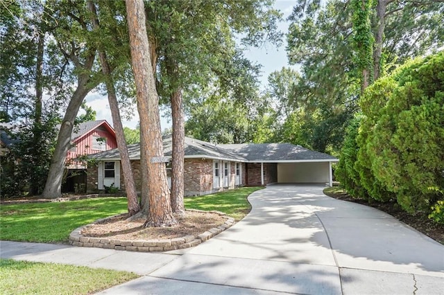 9509 Robin Ln, River Ridge, LA 70123 - view of front of house with driveway, a front yard, an attached carport, and brick siding