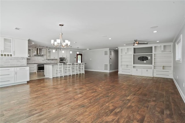 9509 Robin Ln, River Ridge, LA 70123 - unfurnished living room with a chandelier, ceiling fan, dark wood finished floors, baseboards, and recessed lighting