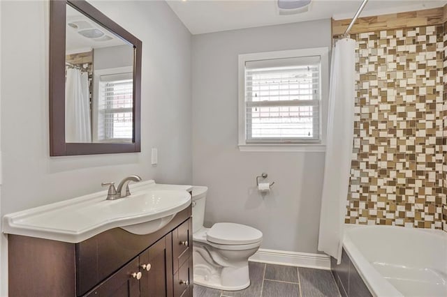 9509 Robin Ln, River Ridge, LA 70123 - full bathroom with toilet, vanity, baseboards, and shower / bathtub combination with curtain