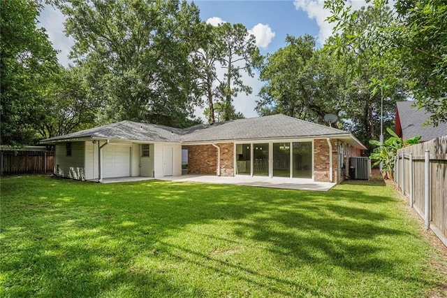 9509 Robin Ln, River Ridge, LA 70123 - rear view of property with central air condition unit, a garage, and a patio