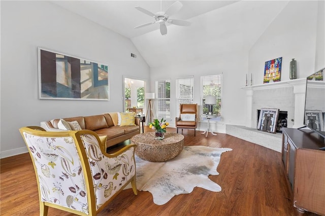 1833 Octavia Dr, Mandeville, LA 70448 - living area with a ceiling fan, wood finished floors, high vaulted ceiling, a brick fireplace, and baseboards