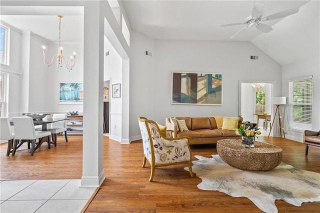 1833 Octavia Dr, Mandeville, LA 70448 - living area with high vaulted ceiling, a chandelier, ceiling fan, baseboards, and light wood finished floors