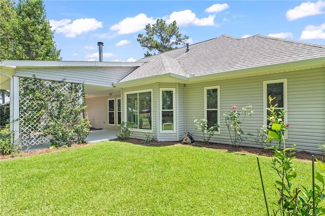 1833 Octavia Dr, Mandeville, LA 70448 - rear view of property featuring a shingled roof, a yard, and a patio