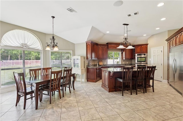 209 Partridge Rd, Slidell, LA 70461 - kitchen featuring a center island, stainless steel appliances, vaulted ceiling, a breakfast bar, and a chandelier