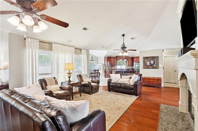 209 Partridge Rd, Slidell, LA 70461 - living area with a ceiling fan, wood finished floors, a fireplace with flush hearth, plenty of natural light, and lofted ceiling