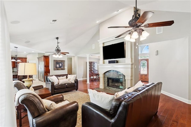 209 Partridge Rd, Slidell, LA 70461 - living room featuring ceiling fan, dark wood-type flooring, baseboards, high vaulted ceiling, and a high end fireplace