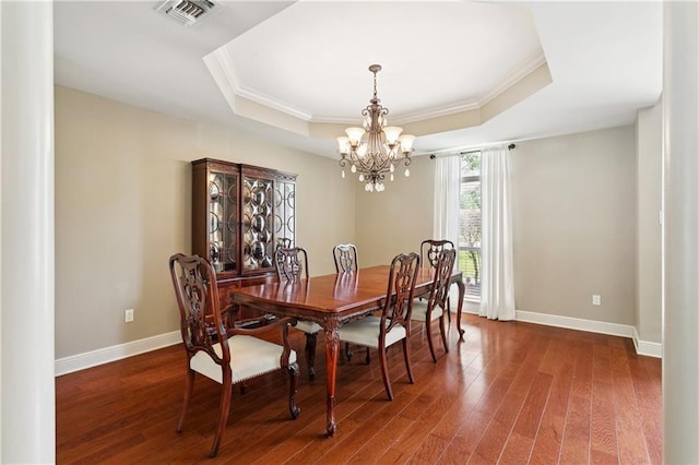 209 Partridge Rd, Slidell, LA 70461 - dining room featuring a raised ceiling, crown molding, a chandelier, wood finished floors, and baseboards