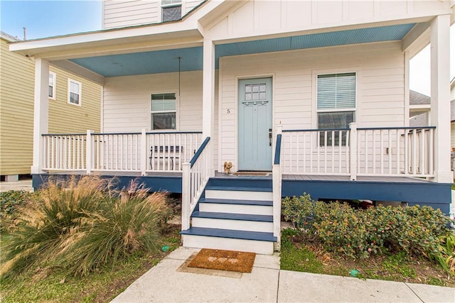 5 Leeward Ct, New Orleans, LA 70131 - entrance to property featuring a porch and board and batten siding