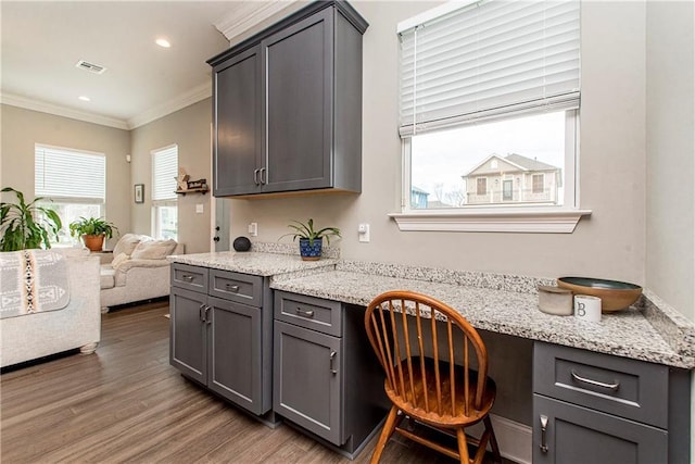 5 Leeward Ct, New Orleans, LA 70131 - kitchen featuring built in study area, crown molding, gray cabinetry, wood finished floors, and open floor plan