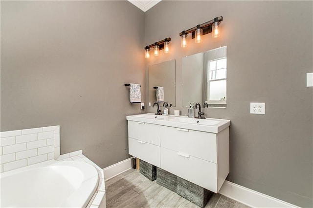 5 Leeward Ct, New Orleans, LA 70131 - bathroom with double vanity, a bath, wood finished floors, and crown molding