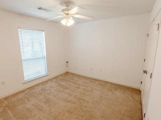 653 Beaulieux St, Mandeville, LA 70448 - spare room with light carpet, a ceiling fan, and baseboards