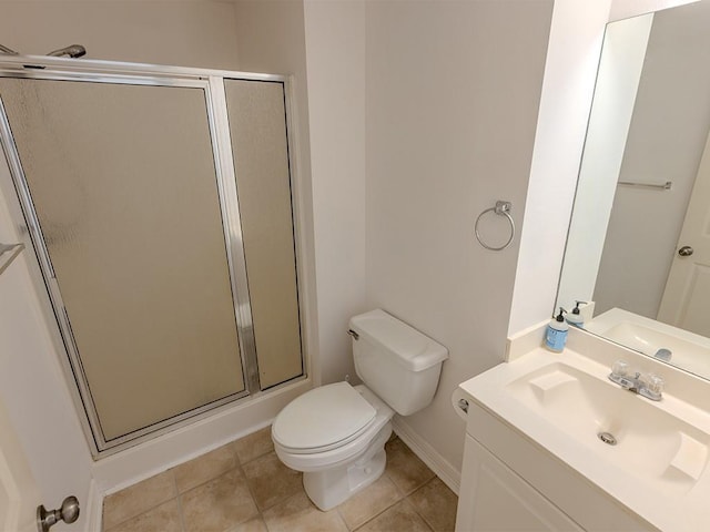 653 Beaulieux St, Mandeville, LA 70448 - bathroom featuring vanity, a stall shower, toilet, baseboards, and tile patterned floors