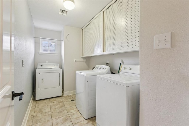 4616 Kawanee Ave, Metairie, LA 70006 - laundry room with washer and clothes dryer, cabinet space, light tile patterned flooring, and baseboards